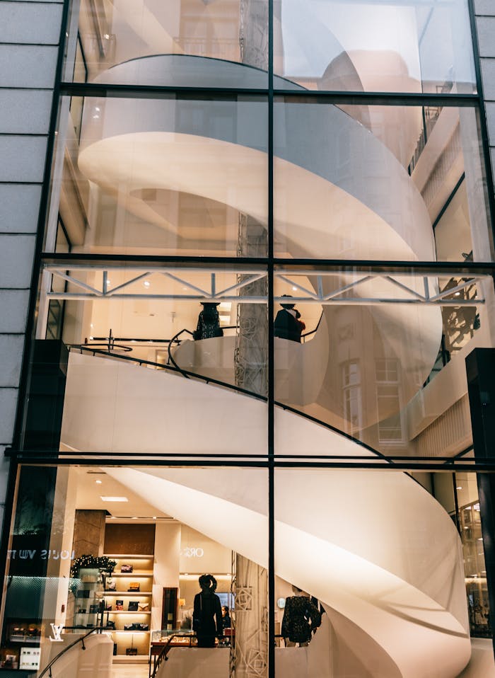 Through glass wall spiral stairs in modern building